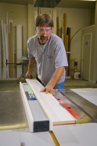 carpenter cutting on table saw